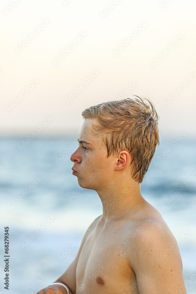 handsome teenager at the beach in sunset handsome teenager at the beach in sunset