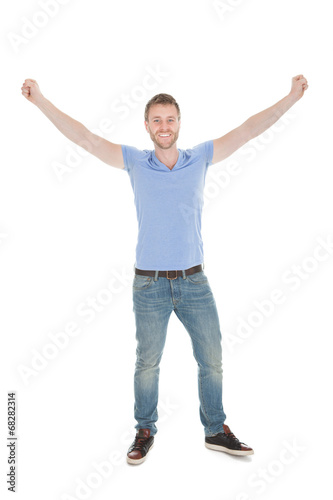 Cheerful Young Man With Hands Raised