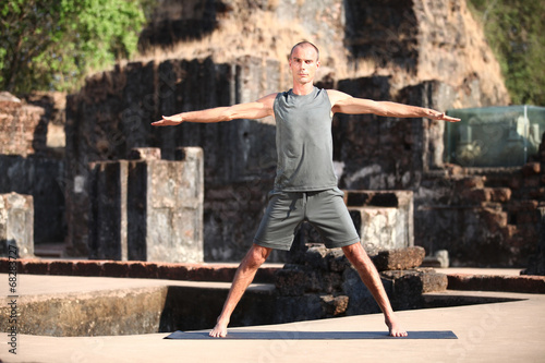 Beautiful yoga position at the ruins of India.