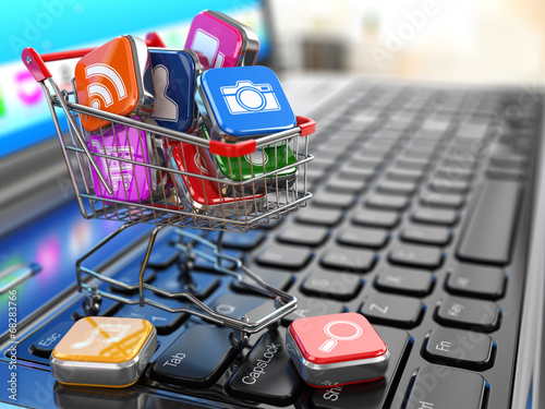 Store of laptop software. Apps icons in shopping cart. photo