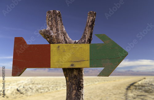 Guinea wooden sign with a desert background photo