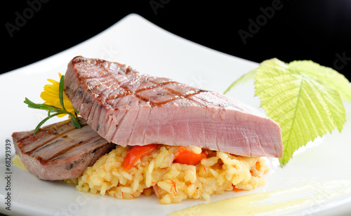 Medium rare sashimi tuna steak on saffron risotto