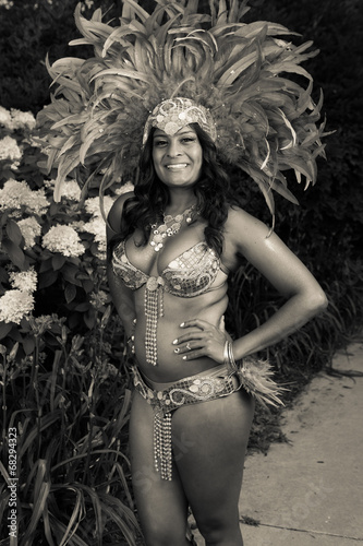 Woman posing and smiling caribana carnival costume black and white feathers