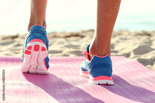 woman running on  the beach. closeup on shoe.
