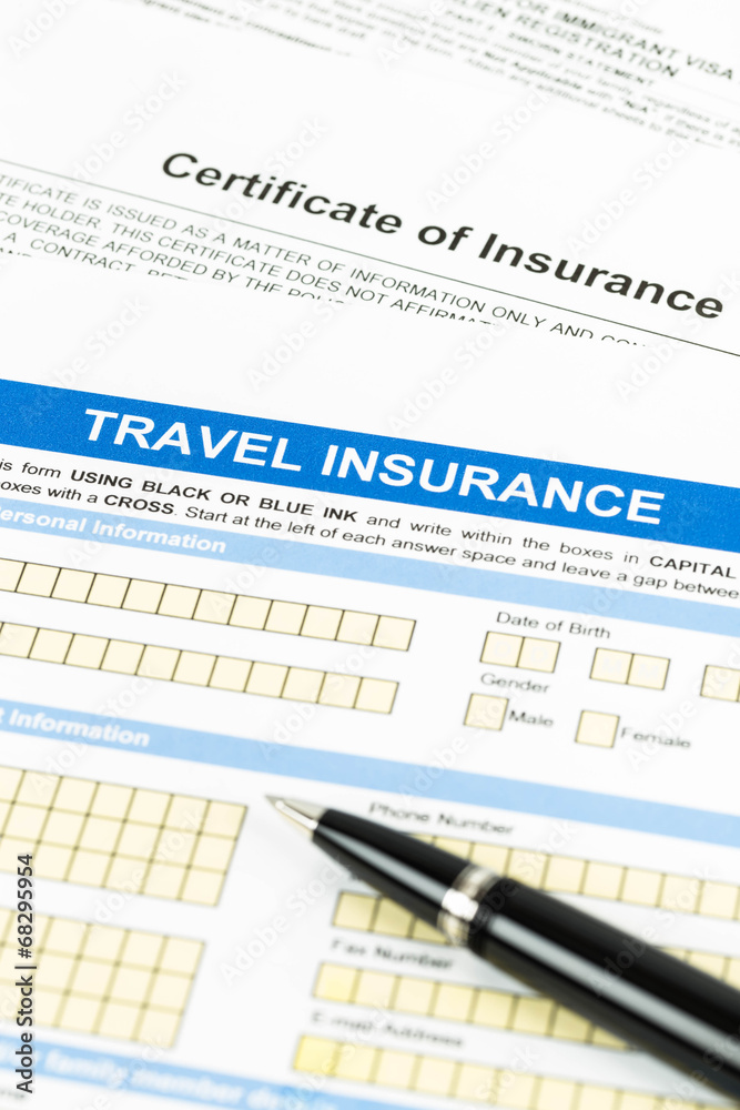 Travel insurance application form with pen Travel insurance application form with pen
