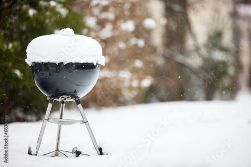 Barbeque grill covered with snow