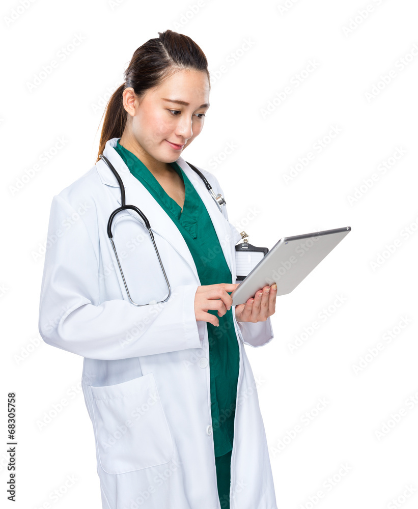 Indonesian female doctor look at digital tablet Indonesian female doctor look at digital tablet