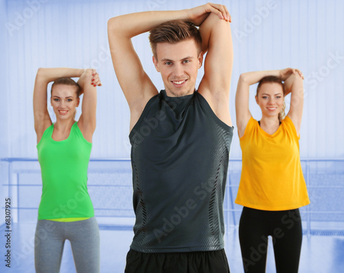 Young people exercising at gym