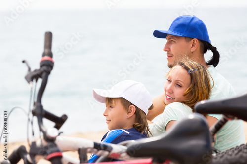 Smiling parents with teenager having rest © JackF