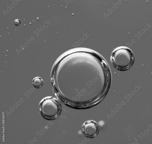 Air bubbles in a liquid. Abstract black-and-white background. ra photo