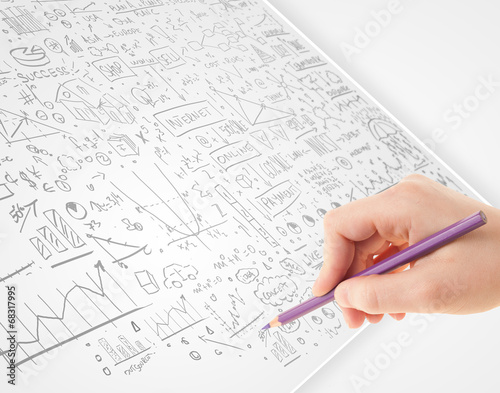 Human hand sketching ideas on a white paper