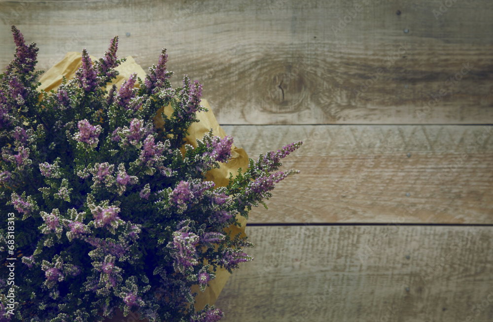 heather flowers over rustic wooden background. heather flowers over rustic wooden background.