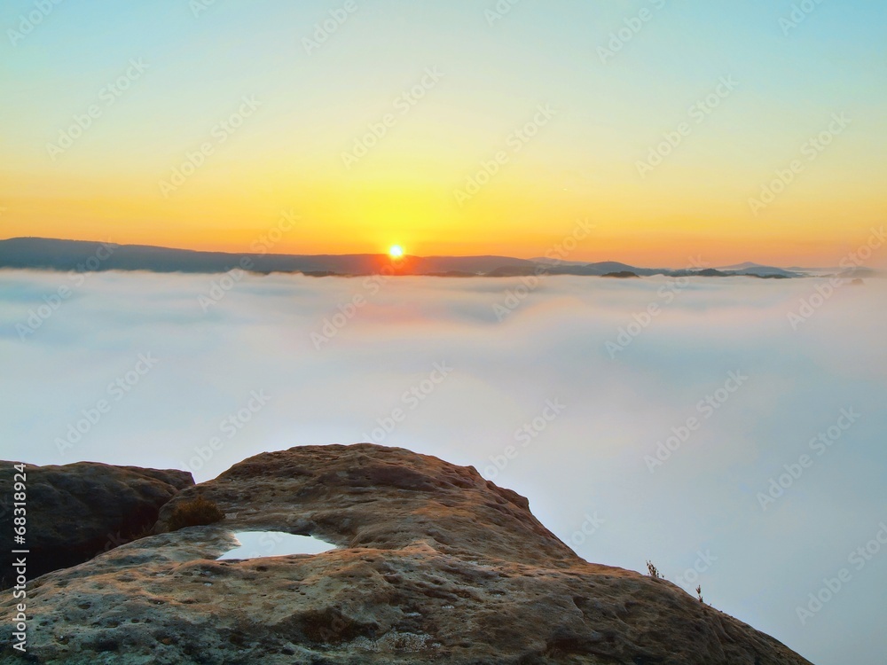 Rock above valley in rocky park full of heavy clouds of dense fo Rock above valley in rocky park full of heavy clouds of dense fo