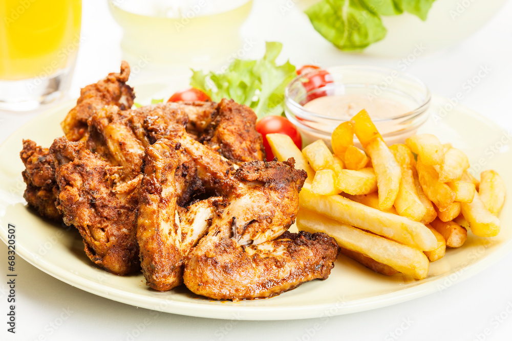 Chicken wings with fries french and spicy sauce Chicken wings with fries french and spicy sauce
