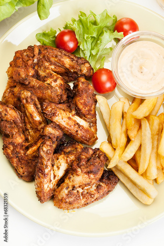 Chicken wings with fries french and spicy sauce