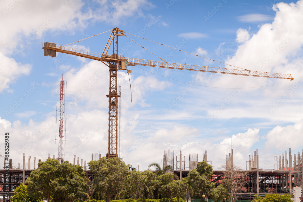 Construction site with cranes on sky background