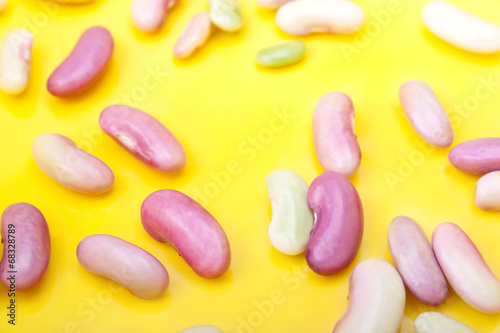 The beans scattered on the yellow background