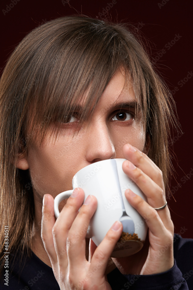 Young man taking a break with cup of coffee Young man taking a break with cup of coffee