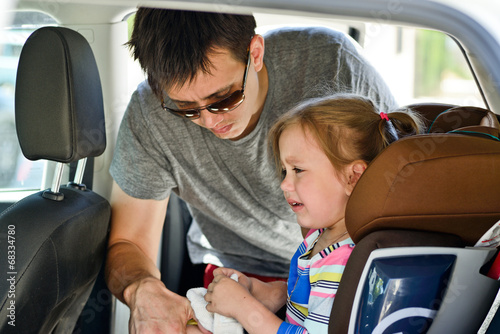father fastening daughter