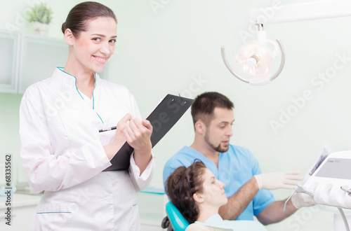 Dentist and his assistant at work