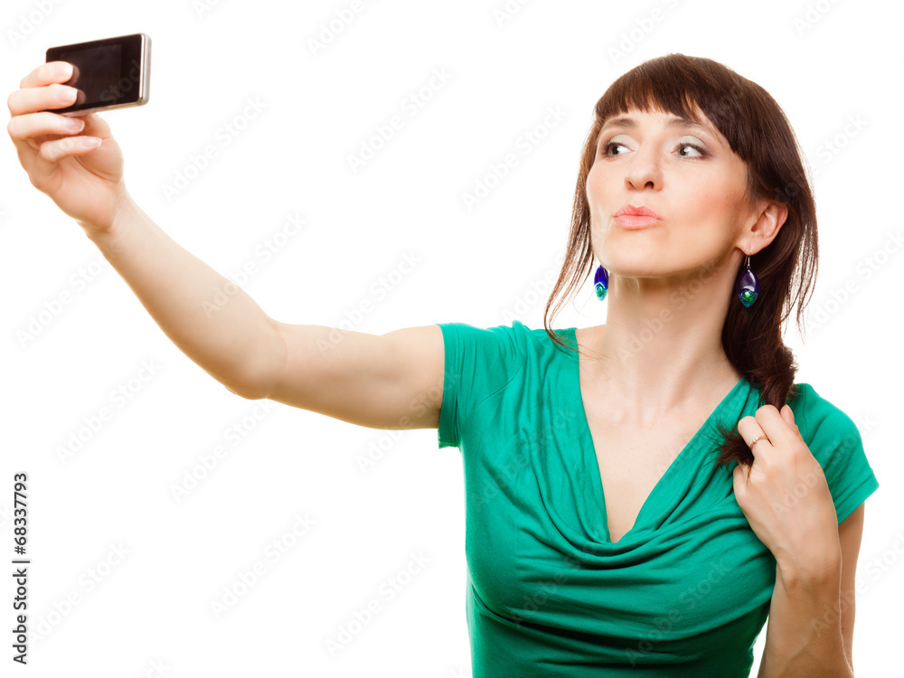 Naklejka premium Happy woman taking self picture with smartphone