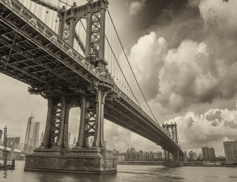 Cloudy evening in New York with Manhattan Bridge side view and c
