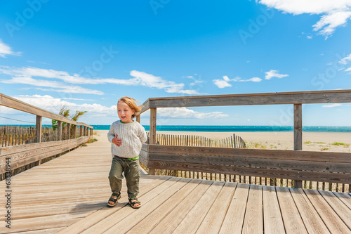 Cute toddler boy having fun outdoors