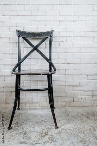 Classic iron chair with white brickbrick photo