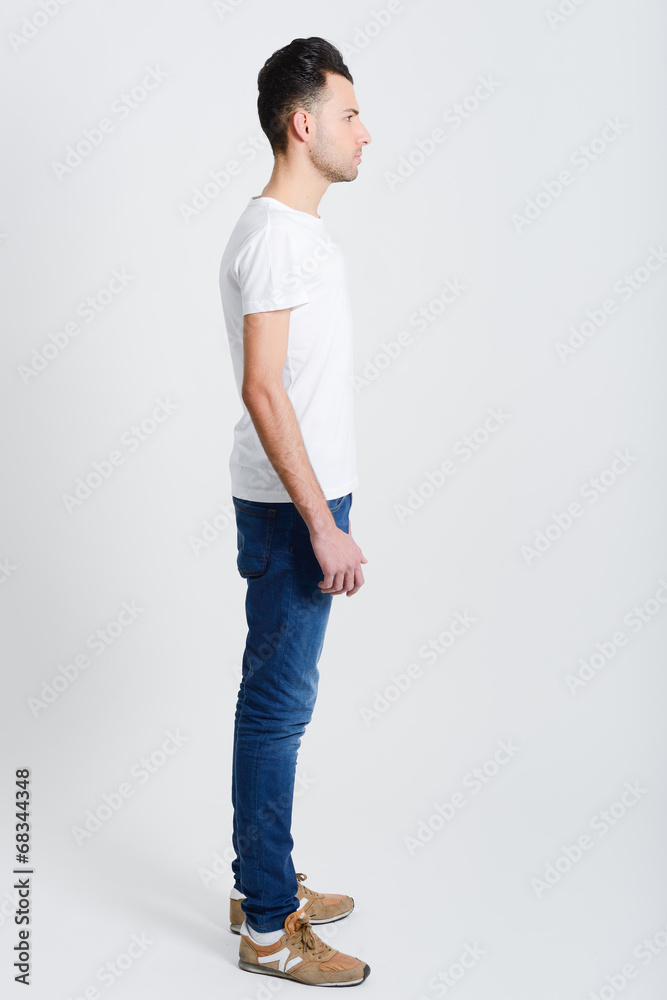 Serious young man standing against white background Serious young man standing against white background