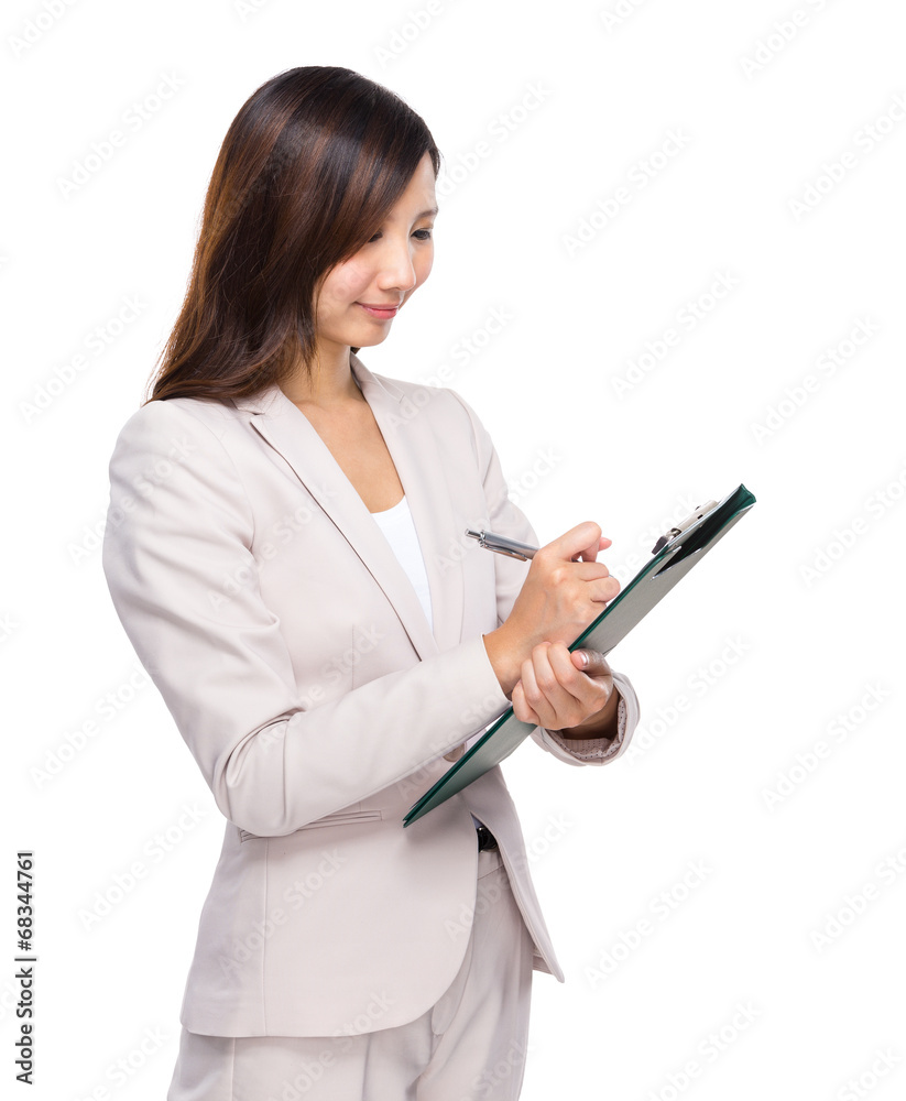 Businessswoman write on clipboard Businessswoman write on clipboard