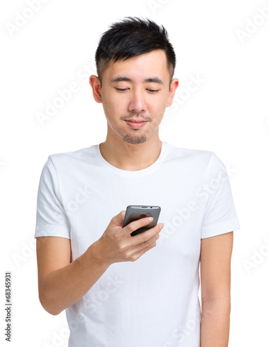 Young man check message on mobile phone © leungchopan