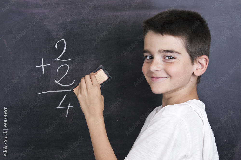child in school blackboard with mathematical formula child in school blackboard with mathematical formula