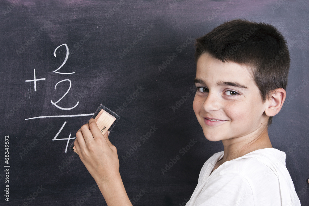 child in school blackboard with mathematical formula