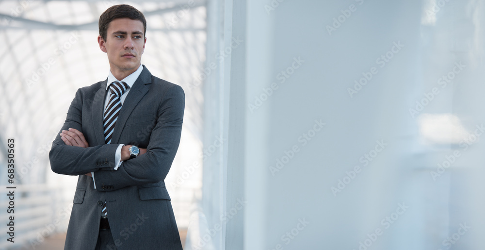 Businessman standing urban surrounding arms crossed