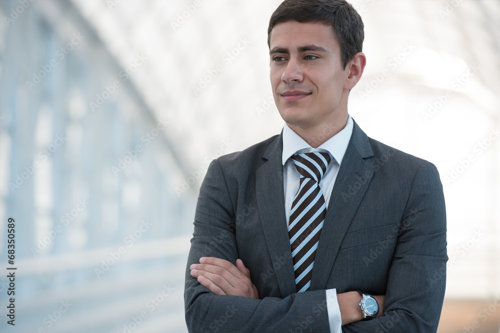 Businessman standing urban surrounding arms crossed Businessman standing urban surrounding arms crossed