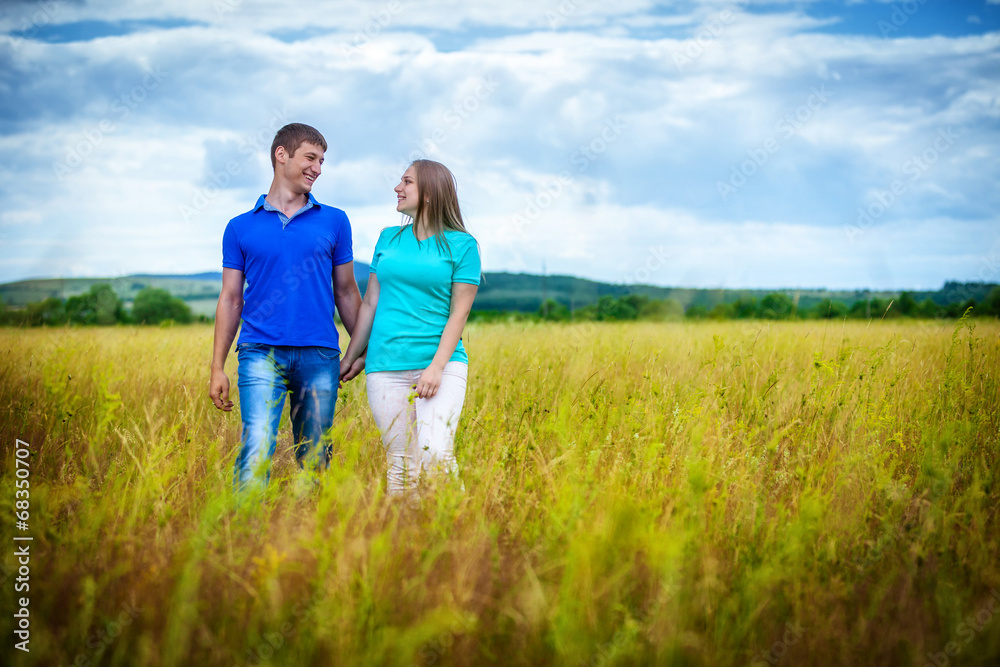 Romantic couple relaxing in field