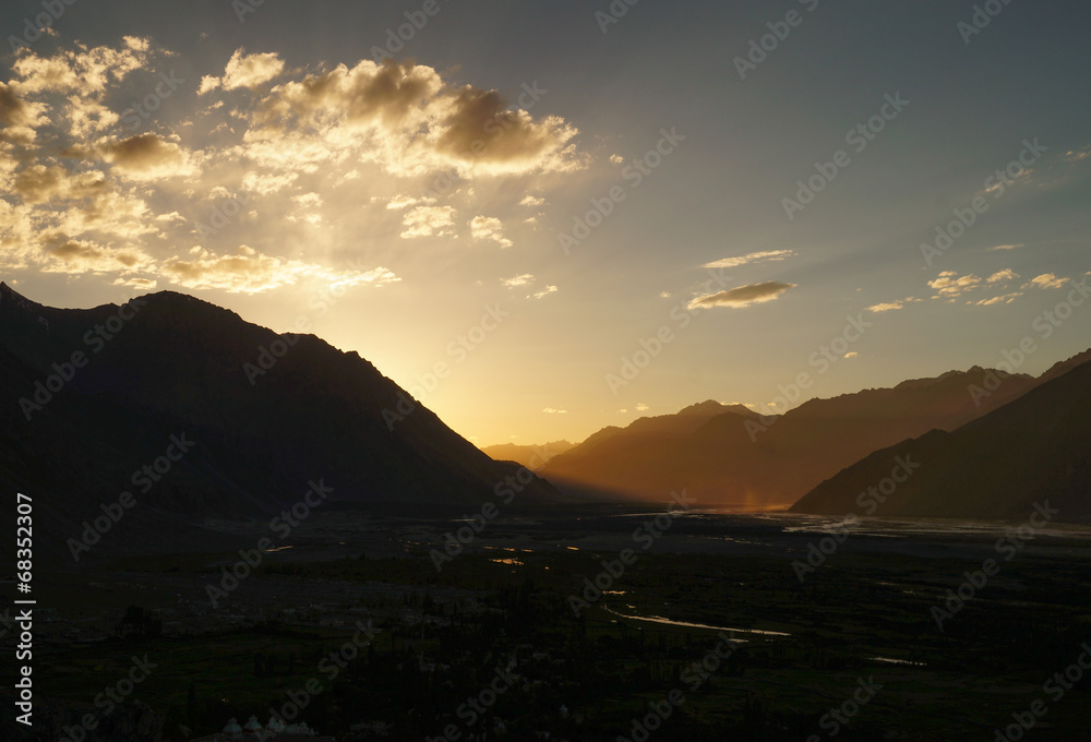 Sunset over Himalayas mountains in Nubra valley near  Diskit Gom