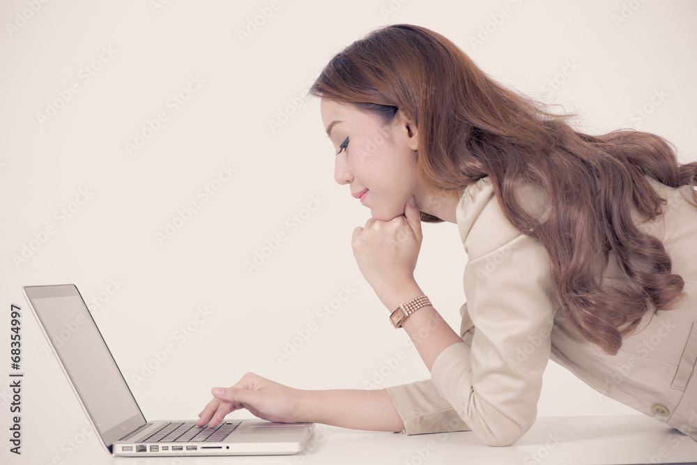 Portrait of a young business woman using laptop at office Portrait of a young business woman using laptop at office