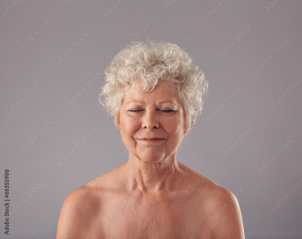 Attractive senior woman with her eyes closed in thought
