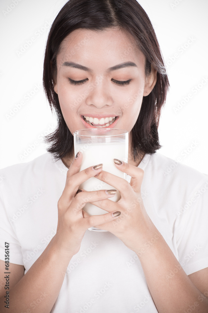 Laughing young woman with a glass of milk Laughing young woman with a glass of milk