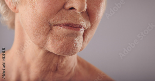 Senior female face with wrinkled skin photo