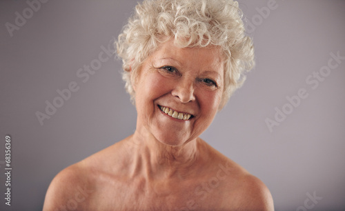 Happy mature female smiling at camera