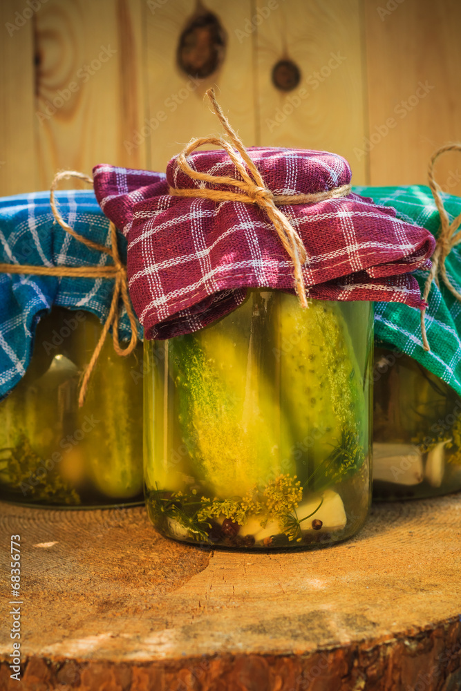 Jars pickled gherkins wooden table