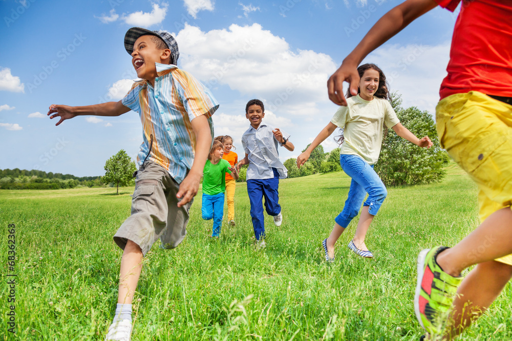Kids in motion of running on green field Kids in motion of running on green field