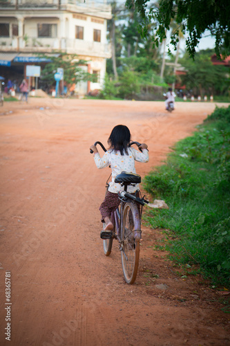 Little girl on the bike in Asia