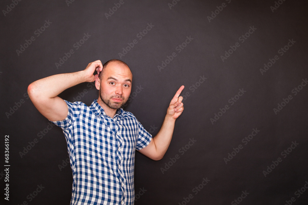 Young happy man pointing his finger Young happy man pointing his finger