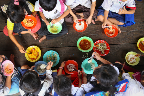 Children having lunch in asian school photo