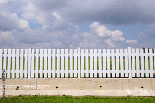 New white fence with with concrete base