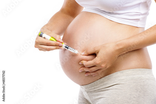 Pregnant woman with syringe photo