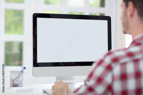 Man in front of computer screen photo